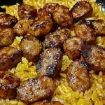 One-pan BBQ sausage and rice dish with golden crispy sausage